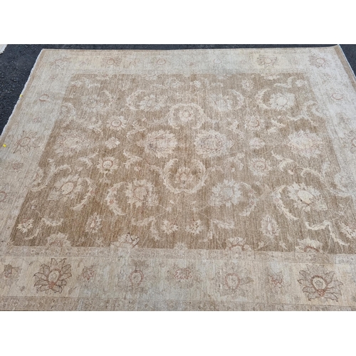 589 - Two large beige Rugs with floral designs, 9ft 8in x 6ft, and 10ft 3in x 7ft 10in