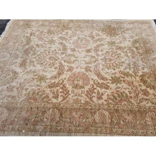 589 - Two large beige Rugs with floral designs, 9ft 8in x 6ft, and 10ft 3in x 7ft 10in