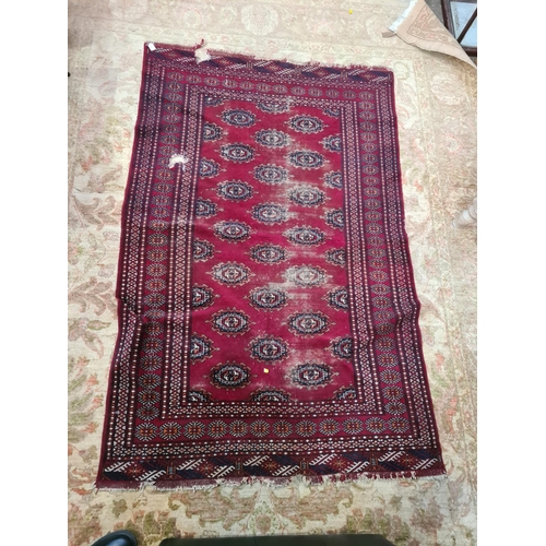 591 - A Persian style red ground Rug with multi borders the centre geometric lozenge designs, A/F, 6ft 7