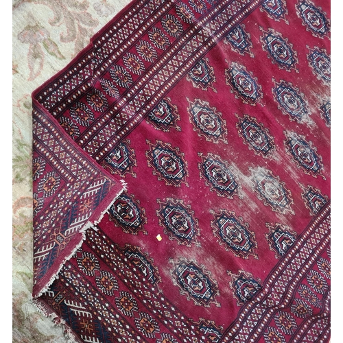 591 - A Persian style red ground Rug with multi borders the centre geometric lozenge designs, A/F, 6ft 7