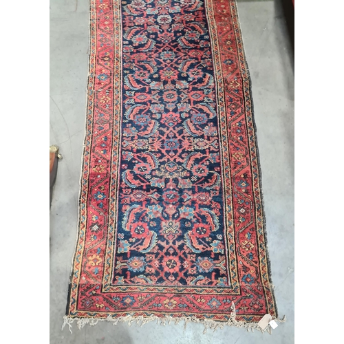 592 - A long antique Persian Runner, mutli-bordered, the centre with floral designs on a blue ground, 20ft... 