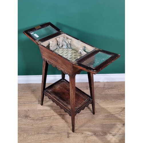 633 - A 19th Century rosewood Sewing Table with double hinged and glazed top on squared tapering supports ... 