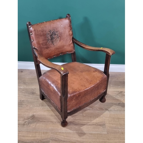 638 - A 1920's leather upholstered Armchair with embossed and studded back (R2)