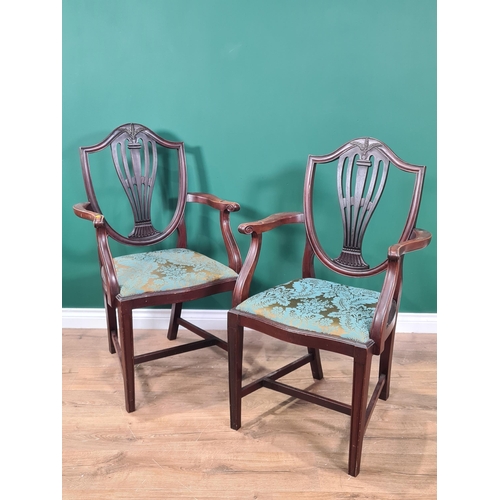 644 - A pair of mahogany framed shield back Elbow Chairs with pierced splats, green floral upholstered sea... 