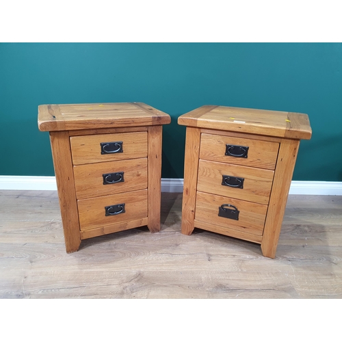 647 - A pair of oak Bedside Chests, each fitted three drawers, 2ft 1in H x 21in W (R6)