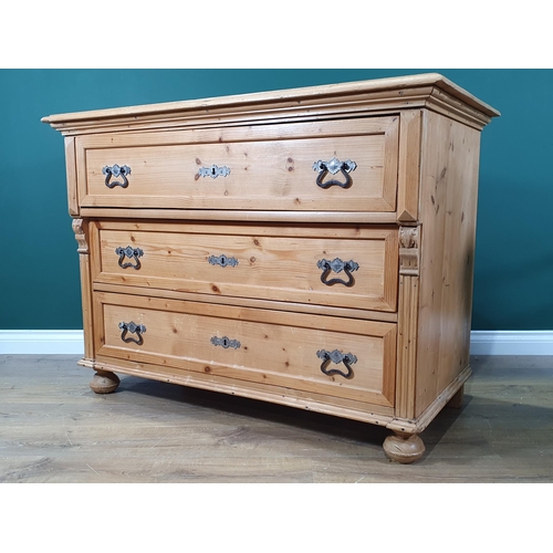 650 - A Continental pine Chest of three long drawers with moulded top, applied carved decoration on turned... 