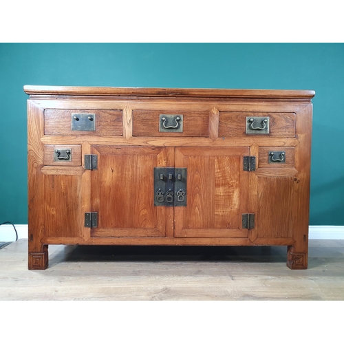 651 - An Oriental elm and other woods Sideboard with moulded top above three fitted drawers with pair of c... 