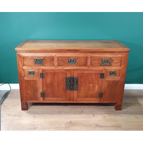 651 - An Oriental elm and other woods Sideboard with moulded top above three fitted drawers with pair of c... 