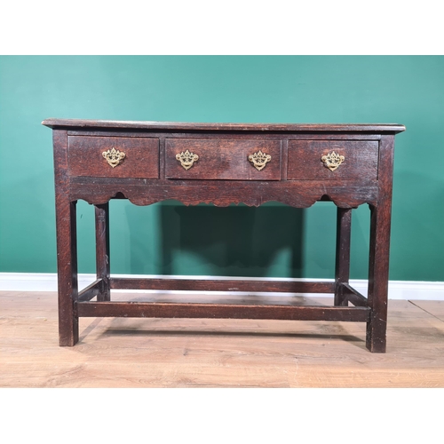 658 - A small oak Dresser Base with moulded top, three fitted drawers above shaped frieze, raised on squar... 