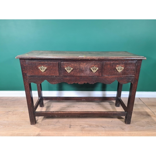 658 - A small oak Dresser Base with moulded top, three fitted drawers above shaped frieze, raised on squar... 