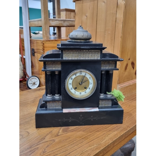 692 - A 19th Century Mantel Clock with figural friezes, the circular dial flanked by columns and raised on... 