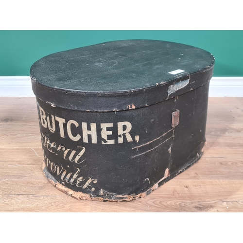 7 - An oval black Storage Box and Cover painted C.B Butcher, General Provider, 2ft (R2)