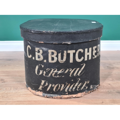 7 - An oval black Storage Box and Cover painted C.B Butcher, General Provider, 2ft (R2)