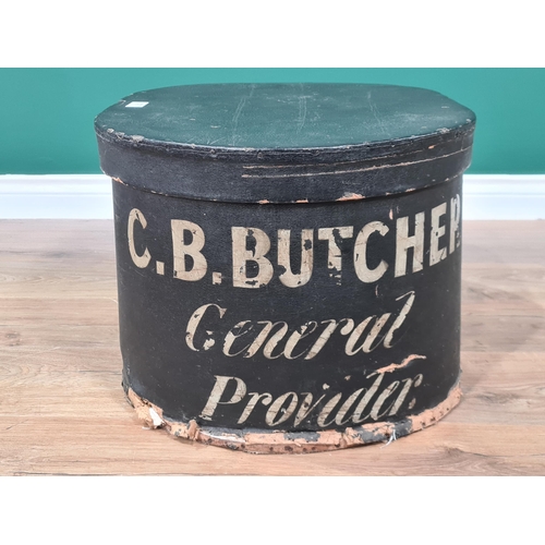 7 - An oval black Storage Box and Cover painted C.B Butcher, General Provider, 2ft (R2)