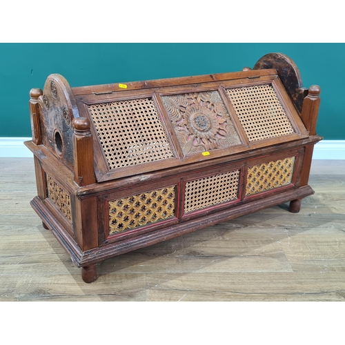 746 - A continental hardwood Hutch/Crib with carved shaped ends, canework and carved panelled lid and side... 