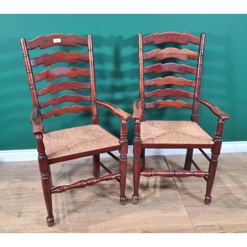 749 - A pair of Ladder Back rush seated Elbow Chairs. (R8).