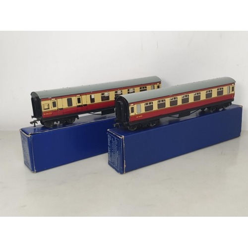 1038 - A scarce pair of Hornby Dublo D12 BR Coaches with LMS bogies in correct early dark blue boxes, M, bo... 