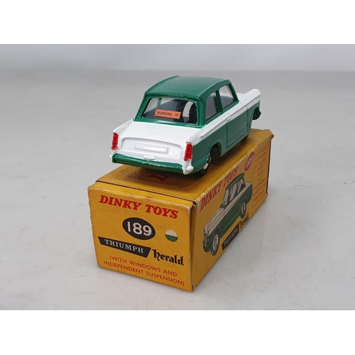 1303 - A boxed Dinky Toys No.189 green and white Triumph Herald, Ex plus, box VG