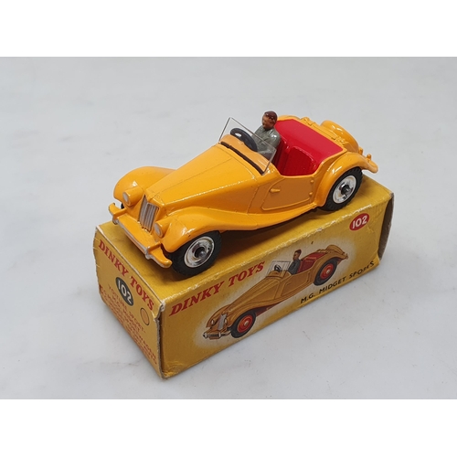 1427 - A rare boxed Dinky Toys No.102 dark yellow M.G. Midget with red interior and spun hubs, Nr M-M, box ... 