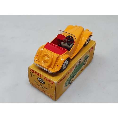 1427 - A rare boxed Dinky Toys No.102 dark yellow M.G. Midget with red interior and spun hubs, Nr M-M, box ... 