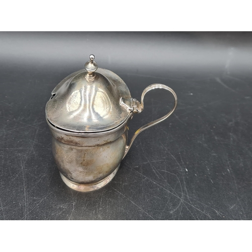 104 - A George III silver oval Mustard Pot, the hinged cover with urn finial, London 1800