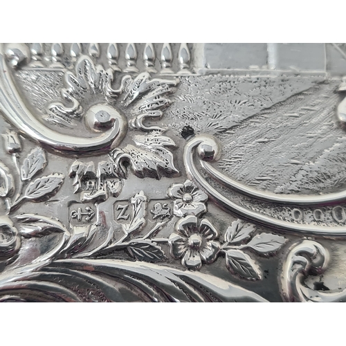 106 - A Victorian silver Card Case finely embossed and chased with formal garden scene within floral and s... 