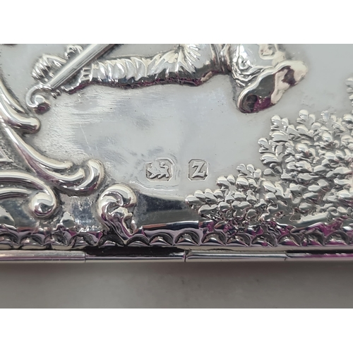 106 - A Victorian silver Card Case finely embossed and chased with formal garden scene within floral and s... 