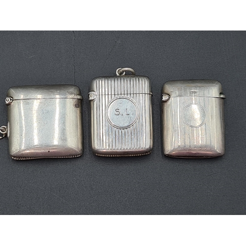 124 - A Victorian silver plain Vesta Case, Birmingham 1897, ribbed Vesta Case, Birmingham 1901, and anothe... 