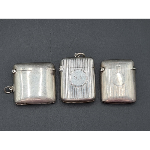 124 - A Victorian silver plain Vesta Case, Birmingham 1897, ribbed Vesta Case, Birmingham 1901, and anothe... 