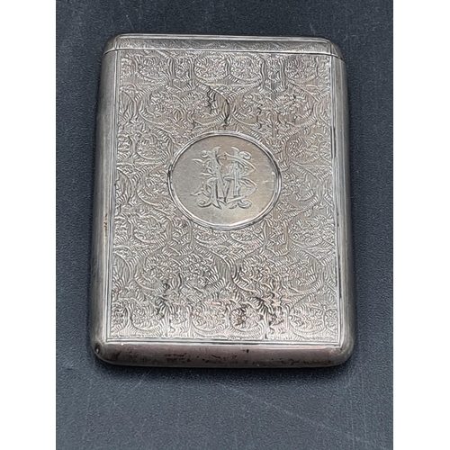 128 - A Victorian silver card Case with patent flip top, scroll engraved, initials in circular reserve, Lo... 