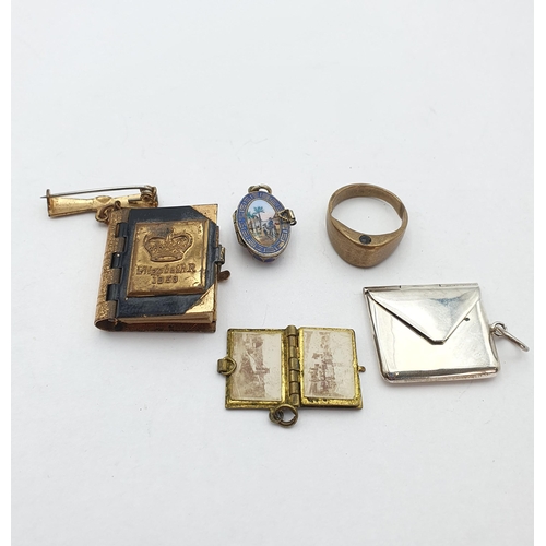 21 - A Silver Stamp Case, an early 20th century Egyptian Moses Basket Charm (complete with Moses), a view... 