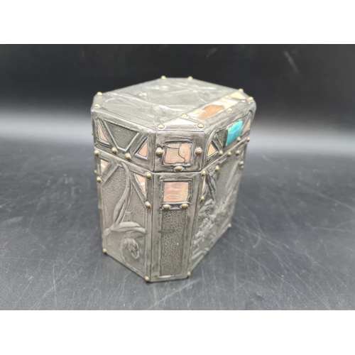 54 - An Arts & Crafts pewter mounted octagonal Tea Caddy with floral embossing and inset Ruskin type pott... 