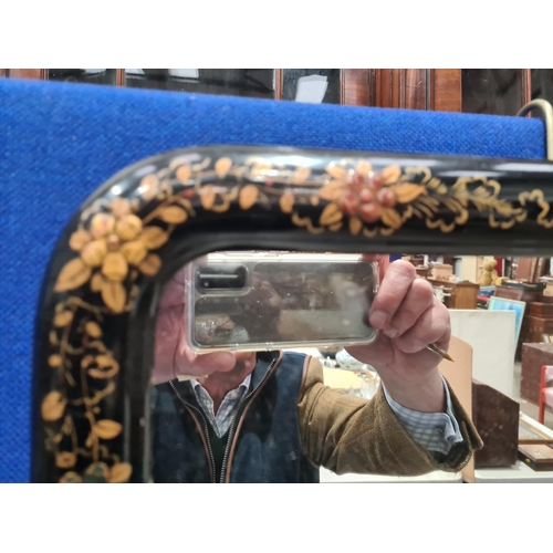 60 - A Chinoiserie Mirror with gilt floral decoration on a black ground