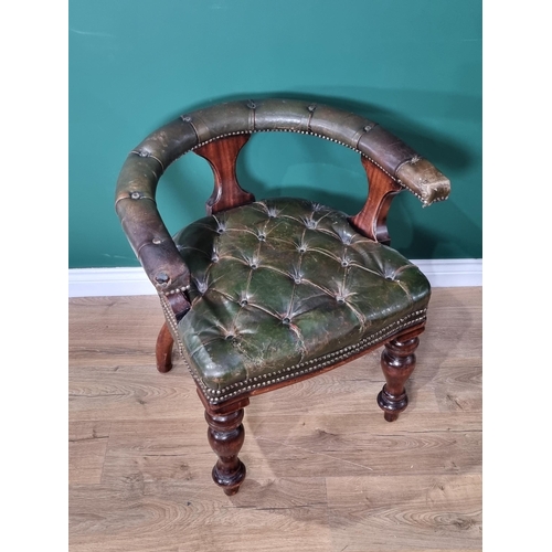 63 - A green button upholstered mahogany framed Captain type Elbow Chair raised on thick turned front sup... 