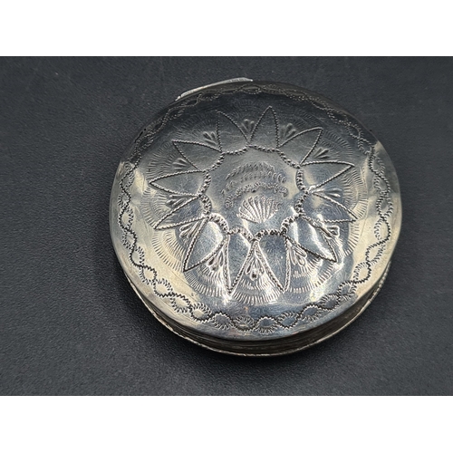 83 - A Continental silver circular Box with bright cut engraving