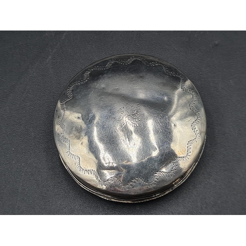 83 - A Continental silver circular Box with bright cut engraving