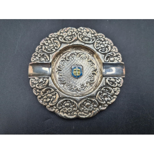 95 - A Continental silver Ashtray floral and scroll embossed, and a plated Spill Vase