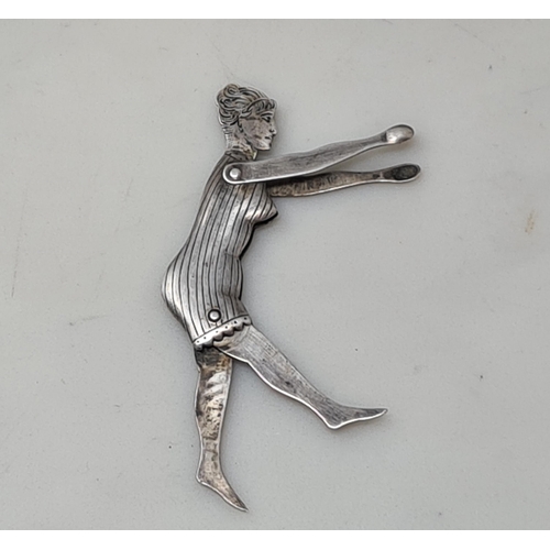 98 - An Art Deco white metal Figure of a Bather with engraved head and folding limbs, and a Figure of Pun... 