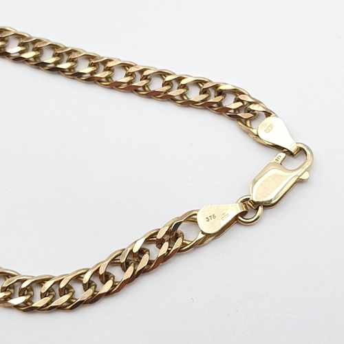 140 - A flattened curb-link Chain with lobster clasp stamped 375, 46.5cm long, approx 21gms