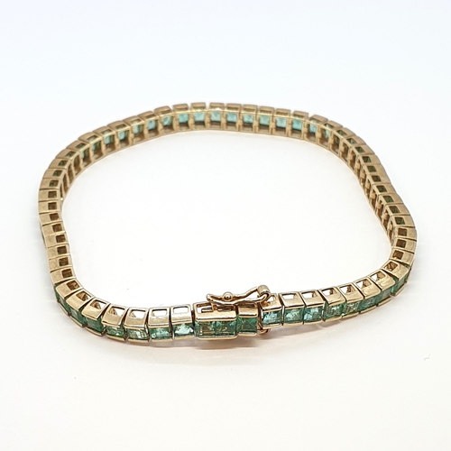 143 - An Emerald Line Bracelet, channel-set calibré-cut green stones in 9ct gold, 19.5cm, approx 11.5gms