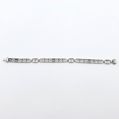 152 - An Art Deco Style Diamond Bracelet consisting of linked panels of millegrain-set marquise-cut and ol... 