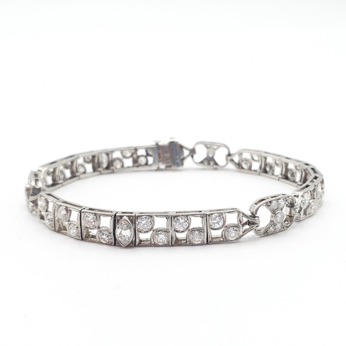 152 - An Art Deco Style Diamond Bracelet consisting of linked panels of millegrain-set marquise-cut and ol... 