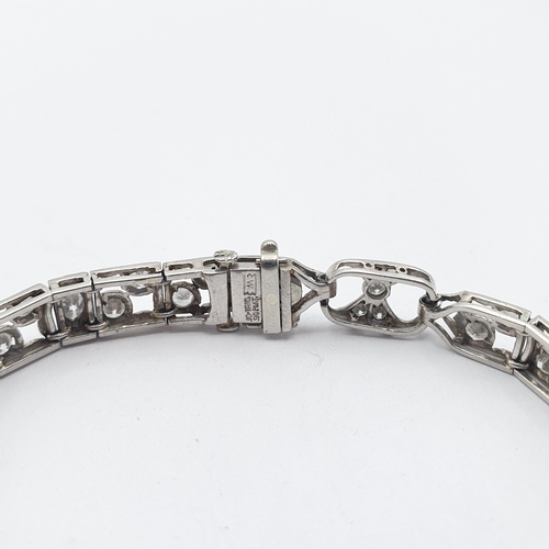 152 - An Art Deco Style Diamond Bracelet consisting of linked panels of millegrain-set marquise-cut and ol... 