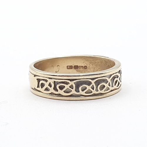 153 - A 9ct gold Ring with Celtic pattern scroll detail and engraved date, ring size P 1/2, approx 4.9gms