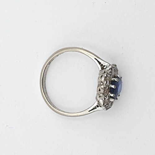 160 - A mid-century Sapphire and Diamond Cluster ring, claw-set oval mixed-cut sapphire, surrounded by ten... 