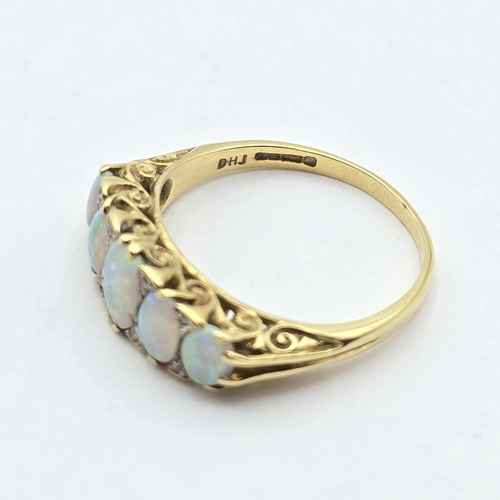 162 - A five stone Opal Ring, claw-set graduated opals interspersed with single-cut diamonds in a scrolled... 