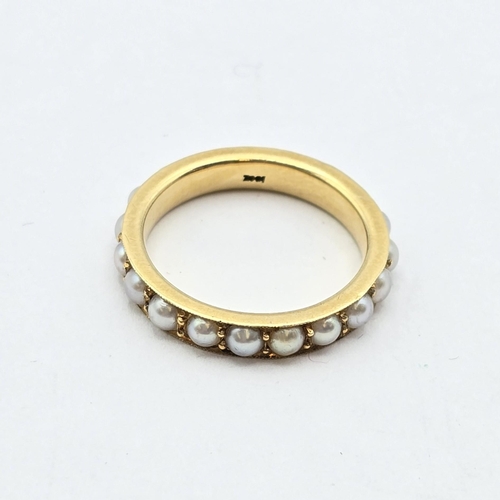 172 - A Pearl-set Eternity Ring in 18ct gold, stamped 18ct, ring size L, 4.1gms