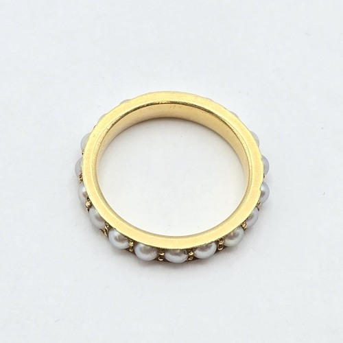 172 - A Pearl-set Eternity Ring in 18ct gold, stamped 18ct, ring size L, 4.1gms