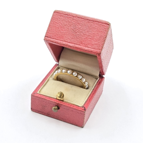 172 - A Pearl-set Eternity Ring in 18ct gold, stamped 18ct, ring size L, 4.1gms