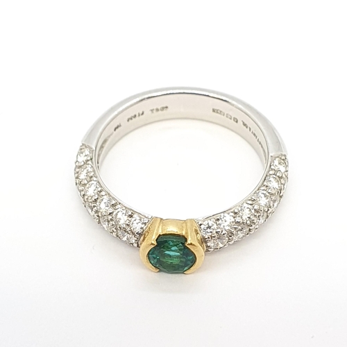 180 - An Emerald and Diamond Ring by Tiffany & Co, half-rubover-set round mixed-cut emerald in yellow gold... 